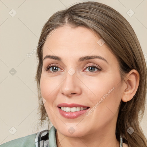 Joyful white adult female with medium  brown hair and brown eyes