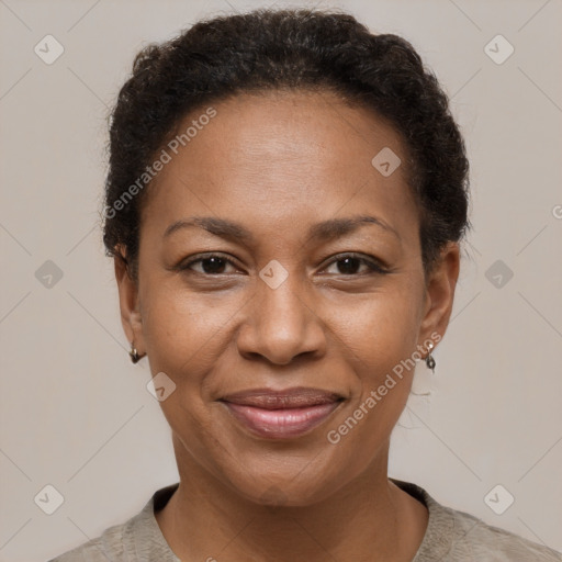 Joyful black adult female with short  brown hair and brown eyes