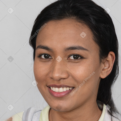 Joyful latino young-adult female with medium  brown hair and brown eyes