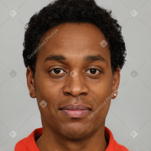 Joyful black young-adult male with short  brown hair and brown eyes