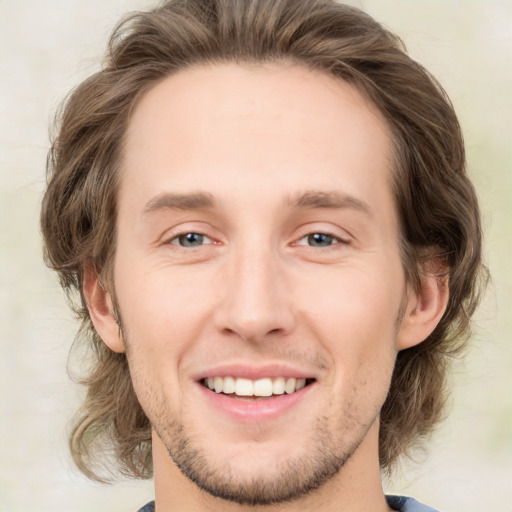 Joyful white young-adult male with medium  brown hair and brown eyes