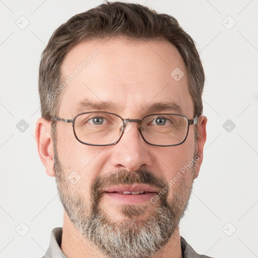 Joyful white adult male with short  brown hair and grey eyes