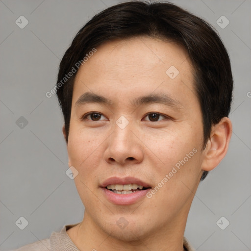 Joyful asian young-adult male with short  brown hair and brown eyes