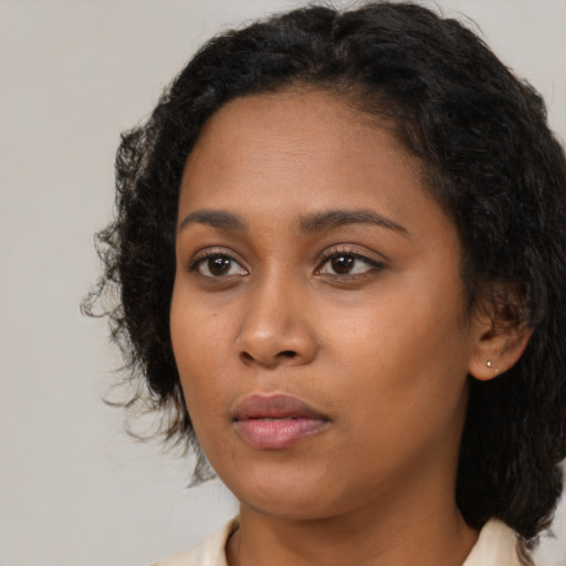 Neutral black young-adult female with medium  black hair and brown eyes