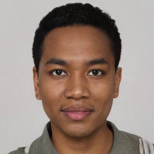 Joyful black young-adult male with short  black hair and brown eyes