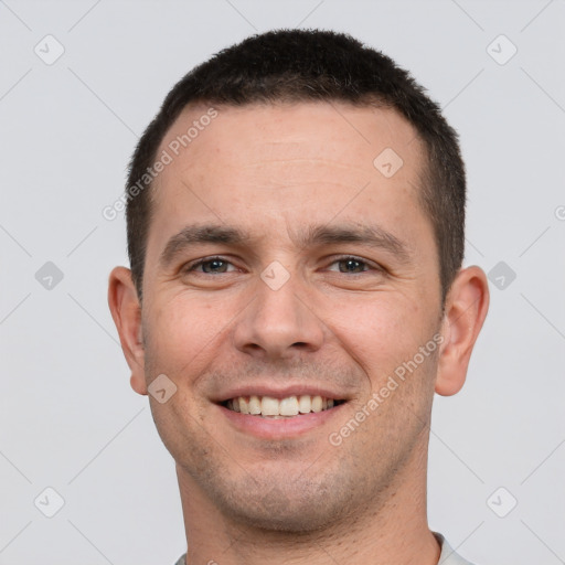 Joyful white young-adult male with short  brown hair and brown eyes