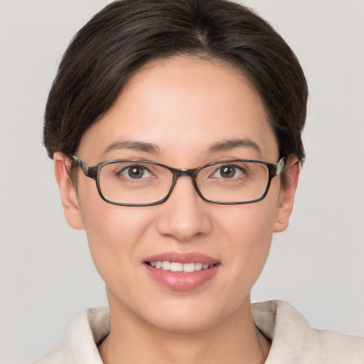 Joyful white young-adult female with short  brown hair and grey eyes