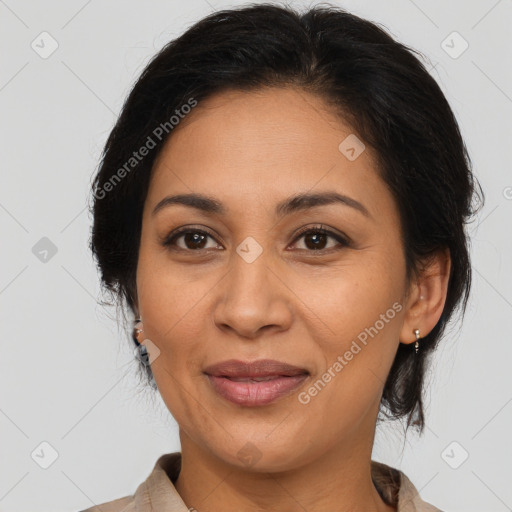 Joyful latino adult female with medium  brown hair and brown eyes