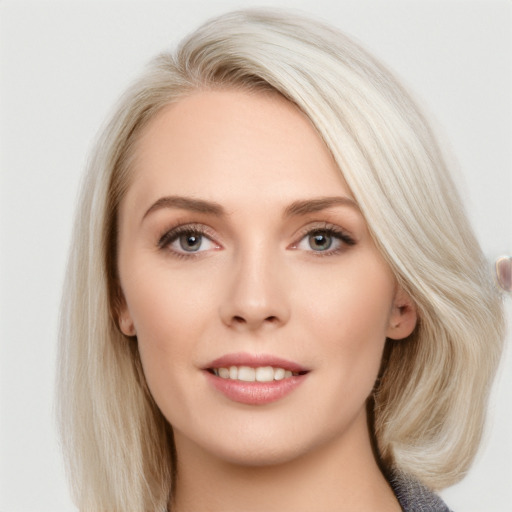 Joyful white young-adult female with long  brown hair and blue eyes