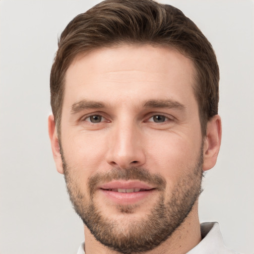 Joyful white young-adult male with short  brown hair and brown eyes