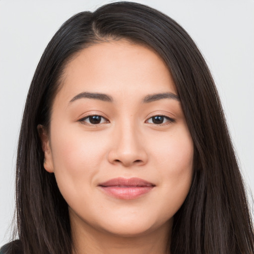 Joyful asian young-adult female with long  brown hair and brown eyes