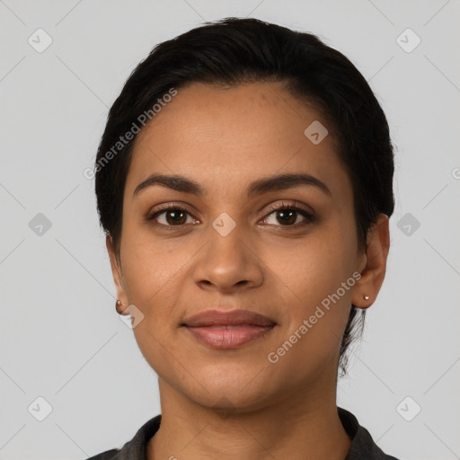 Joyful latino young-adult female with short  black hair and brown eyes