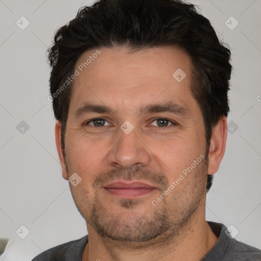 Joyful white adult male with short  brown hair and brown eyes