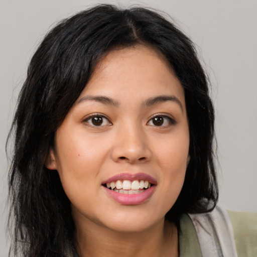 Joyful asian young-adult female with long  brown hair and brown eyes