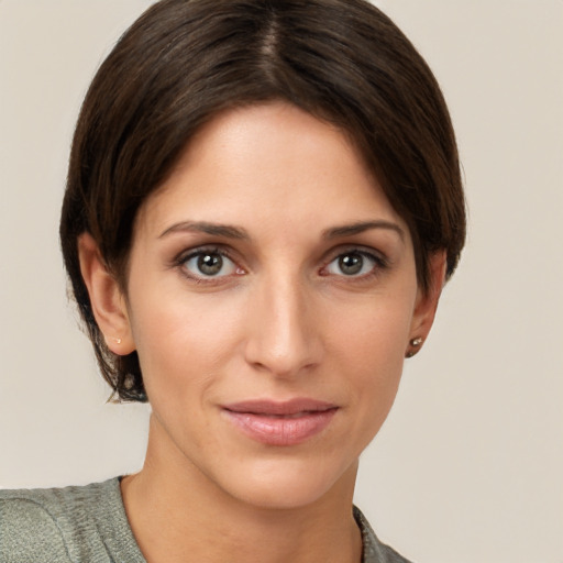 Joyful white young-adult female with short  brown hair and grey eyes