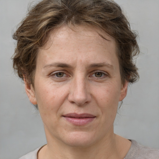 Joyful white adult female with short  brown hair and grey eyes