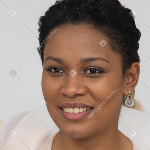 Joyful black young-adult female with short  brown hair and brown eyes