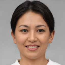 Joyful asian young-adult female with medium  brown hair and brown eyes