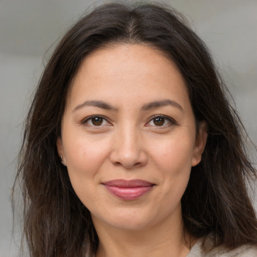 Joyful white adult female with long  brown hair and brown eyes