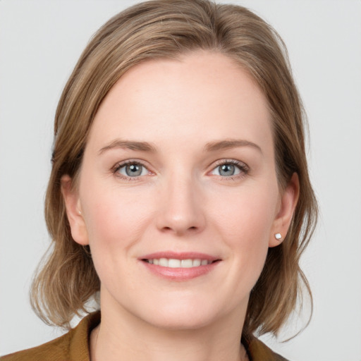 Joyful white young-adult female with medium  brown hair and blue eyes