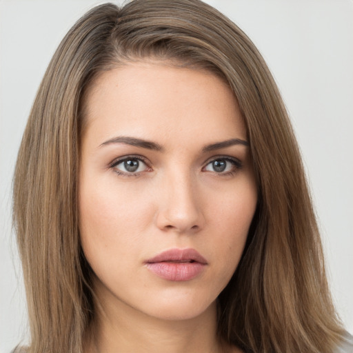 Neutral white young-adult female with long  brown hair and brown eyes