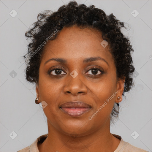 Joyful black adult female with short  brown hair and brown eyes