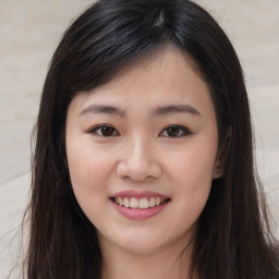 Joyful asian young-adult female with long  brown hair and brown eyes