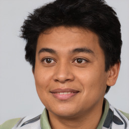 Joyful latino young-adult male with short  brown hair and brown eyes