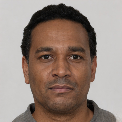 Neutral latino adult male with short  black hair and brown eyes