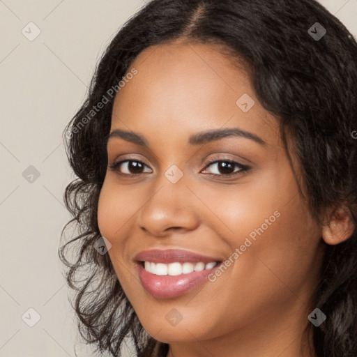 Joyful latino young-adult female with long  black hair and brown eyes