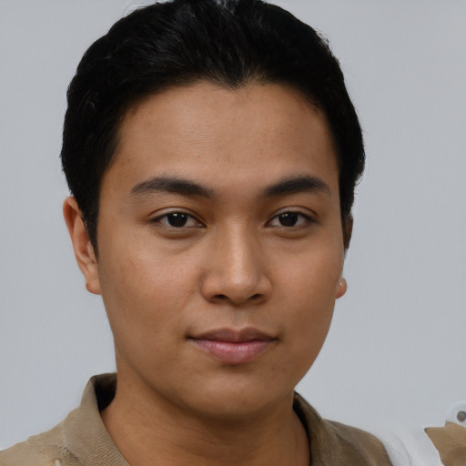 Joyful asian young-adult male with short  brown hair and brown eyes