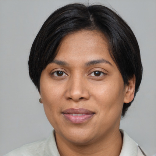 Joyful asian adult female with short  black hair and brown eyes