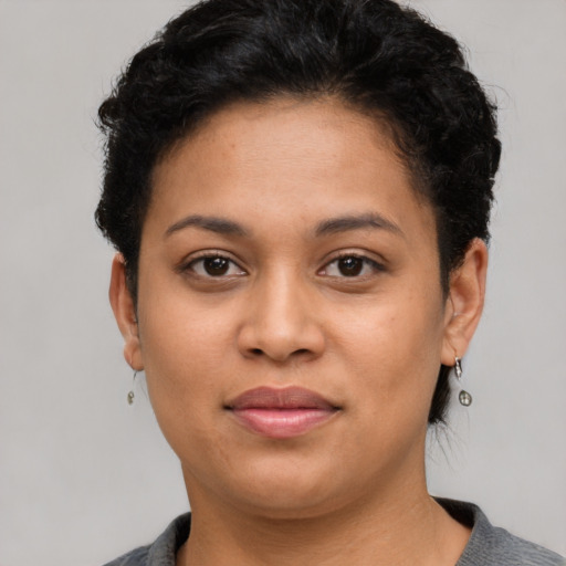 Joyful latino young-adult female with short  brown hair and brown eyes