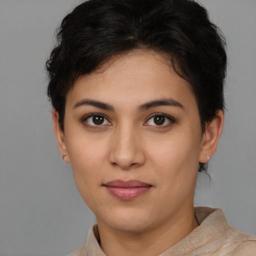 Joyful latino young-adult female with short  brown hair and brown eyes