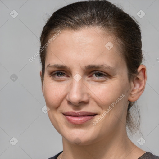 Joyful white adult female with medium  brown hair and grey eyes