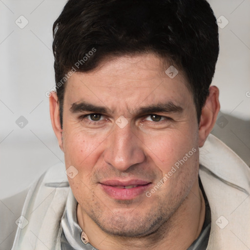 Joyful white adult male with short  brown hair and brown eyes