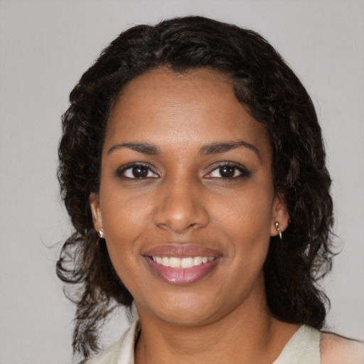 Joyful black young-adult female with medium  black hair and brown eyes