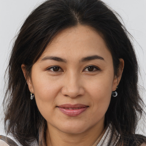 Joyful asian young-adult female with long  brown hair and brown eyes