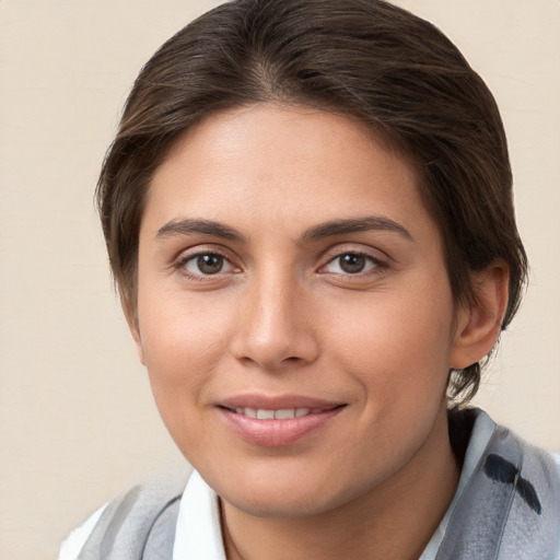 Joyful white young-adult female with medium  brown hair and brown eyes