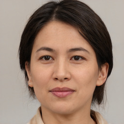 Joyful asian adult female with medium  brown hair and brown eyes