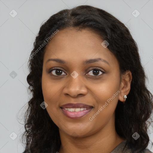 Joyful black young-adult female with long  brown hair and brown eyes