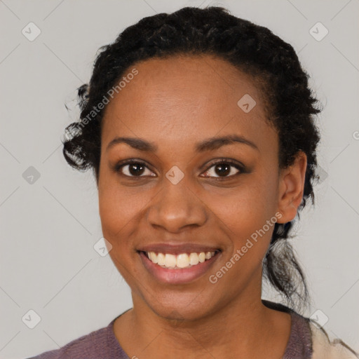 Joyful black young-adult female with medium  black hair and brown eyes