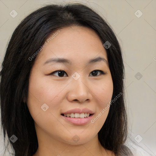 Joyful asian young-adult female with long  brown hair and brown eyes