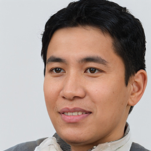 Joyful asian young-adult male with short  black hair and brown eyes