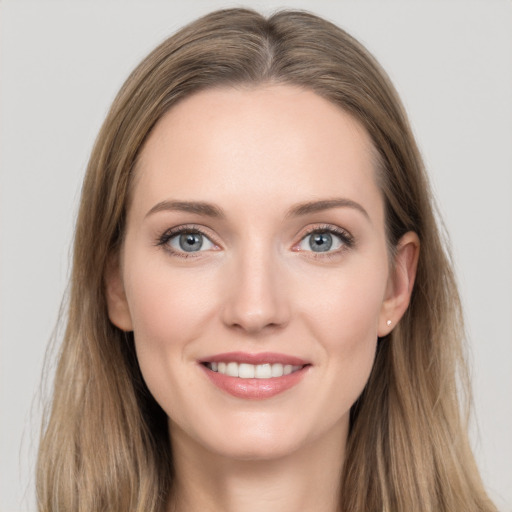 Joyful white young-adult female with long  brown hair and grey eyes