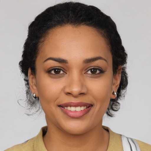 Joyful latino young-adult female with short  brown hair and brown eyes