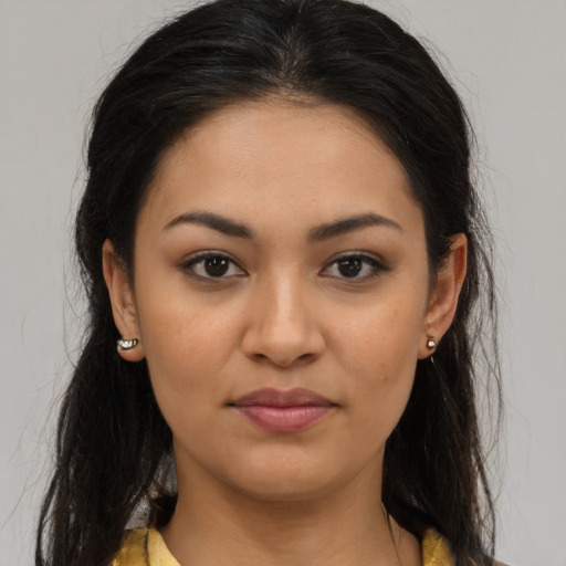 Joyful latino young-adult female with long  brown hair and brown eyes