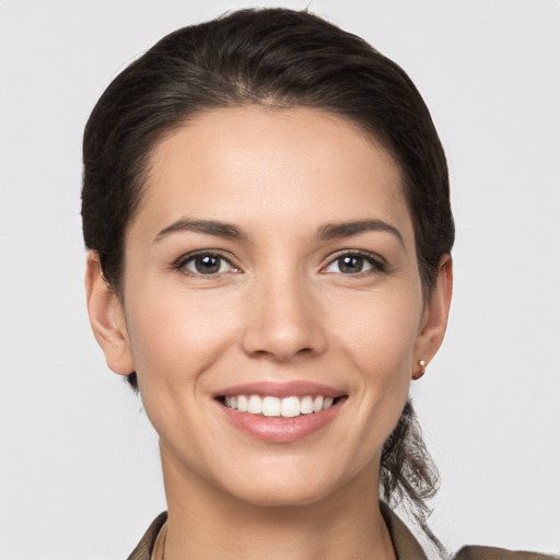 Joyful white young-adult female with short  brown hair and brown eyes