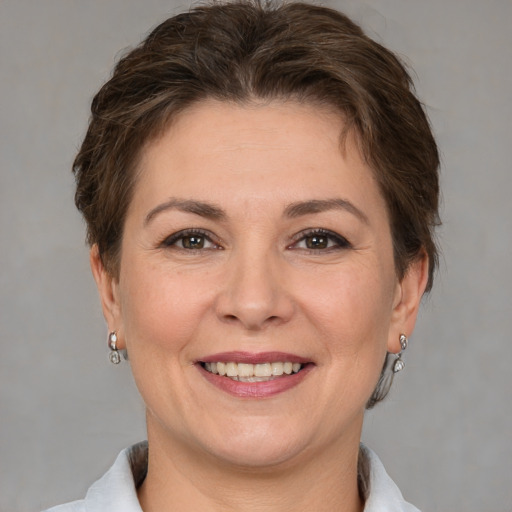 Joyful white adult female with short  brown hair and brown eyes