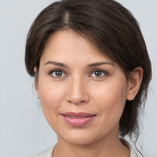 Joyful white young-adult female with medium  brown hair and brown eyes